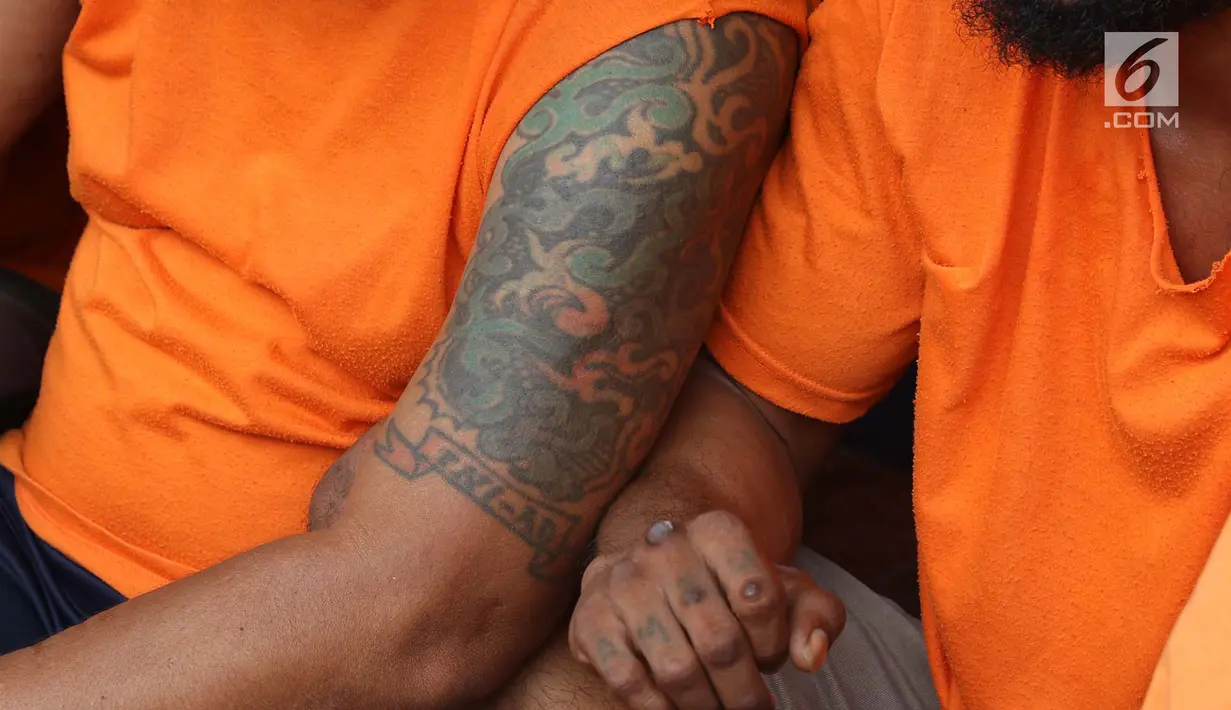 Tato tersangka kasus premanisme di Mapolres Metro Jakarta Barat, Senin (12/11). Polisi menangkap 23 pria dari dua kasus berbeda karena  tindakan perusakan, intimidasi, pengusiran, dan penguasaan lahan di Jakbar. (Liputan6.com/Immanuel Antonius)