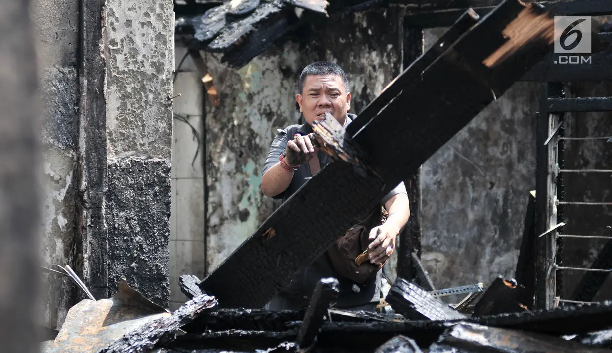 Warga mencari barang yang tersisa di rumahnya usai kebakaran di kawasan Krukut, Tamansari, Jakarta, Selasa (26/2). Kebakaran disebabkan edakan kompor dari salah satu rumah warga yang kemudian merembet ke pemukiman lain. (Merdeka.com/Iqbal S Nugroho)
