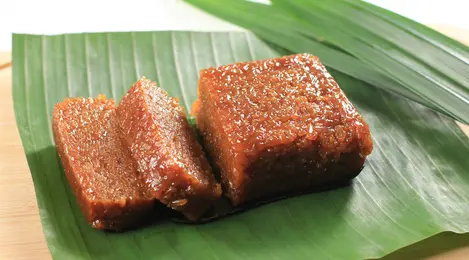 Potongan wajik ketan gula merah yang legit dan kenyal, disajikan dalam piring tradisional