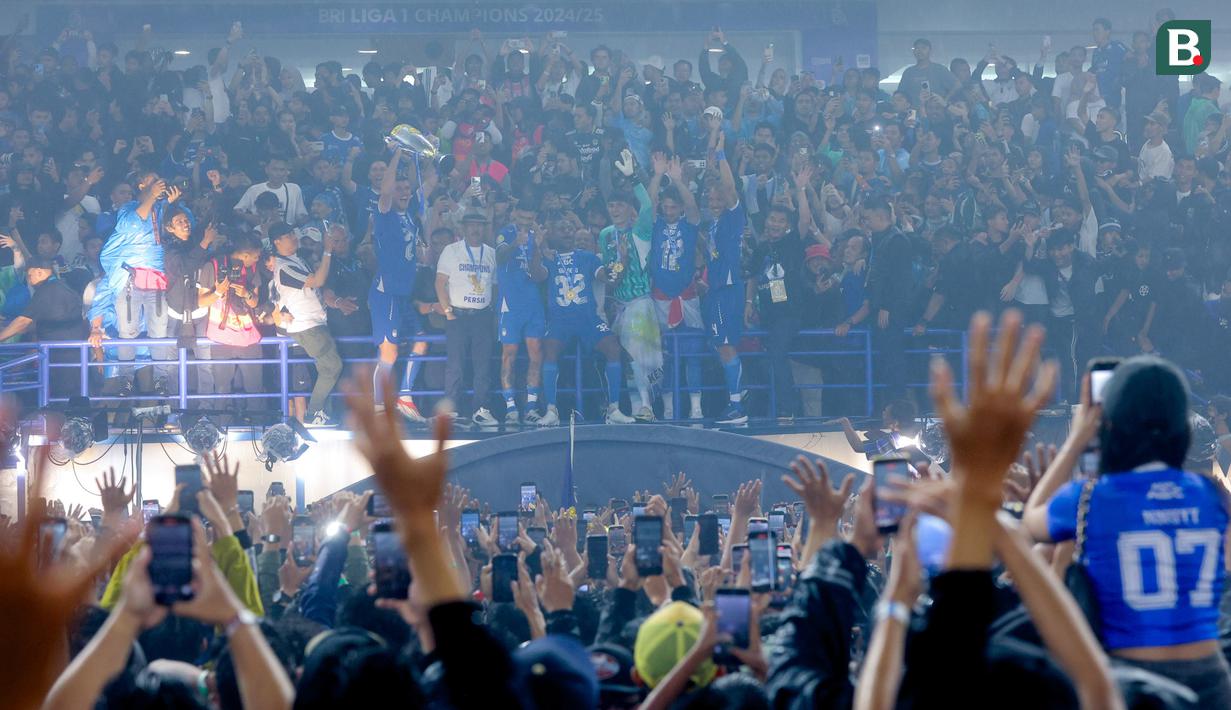 Pemain Persib Bandung mengangkat trofi saat pesta juara BRI Liga 1 2024/2025 di Stadion Gelora Bandung Lautan Api, Sabtu (24/5/2025) sore WIB. (Bola.com/M Iqbal Ichsan)