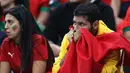 Reaksi suporter Maroko di akhir pertandingan setelah tim yang didukung kalah 0-2 dalam pertandingan sepak bola semifinal Piala Dunia Qatar 2022 antara Prancis dan Maroko di Stadion Al-Bayt di Al Khor, Doha, Qatar, Kamis (15/12/2022). Meski harus mengubur mimpi menjadi juara Piala Dunia 2022, Maroko tetap mengucap syukur dengan melakukan sujud syukur di lapangan setelah pertandingan usai. (ADRIAN DENNIS / AFP)