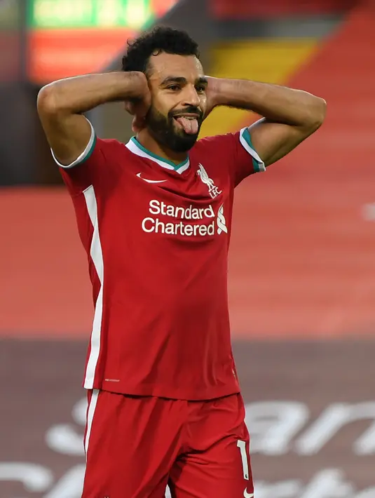 Penyerang Liverpool, Mohamed Salah merayakan gol yang dicetaknya melalui tendangan penalti ke gawang Leeds United pada pekan pertama Premier League di Stadion Anfield, Sabtu (12/9/2020). Mo Salah mencetak hattrick saat membawa Liverpool menang 4-3 atas Leeds United. (Shaun Botterill/POOL/AFP)