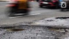 Sejumlah pengendara kendaraan bermotor melewati salah satu titik kerusakan di Jalan Raya Parung-Ciputat Kota Depok, Jawa Barat, Senin (10/2/2025). (Magang/Liputan6.com/Muhammad Rizal)
