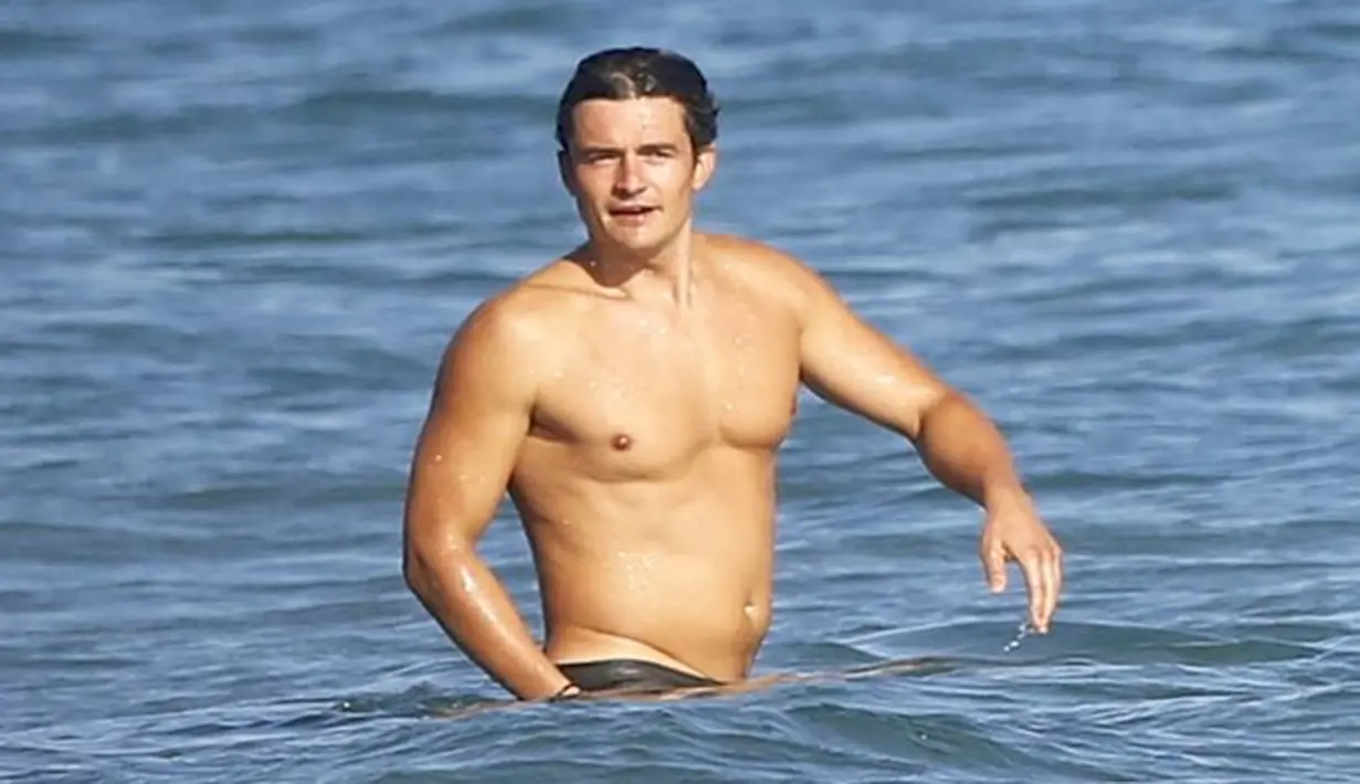 Orlando Bloom melepaskan celana pantainya sebelum mengarungi laut dengan perahu yang didayunginya. Anehnya, apa alasan Orlando Bloom melakukan bugil di tempat yang terbuka?. (Dailymail/Bintang.com)