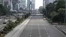 Warga menyeberang melintasi jalan protokol yag lengang di kawasan MH Thamrin, Jakarta, Selasa (6/7). Hampir semua jalan di Ibu Kota lengang saat sebagian besar warga mudik untuk merayakan Lebaran di kampung halaman. (Liputan6.com/Faizal Fanani)