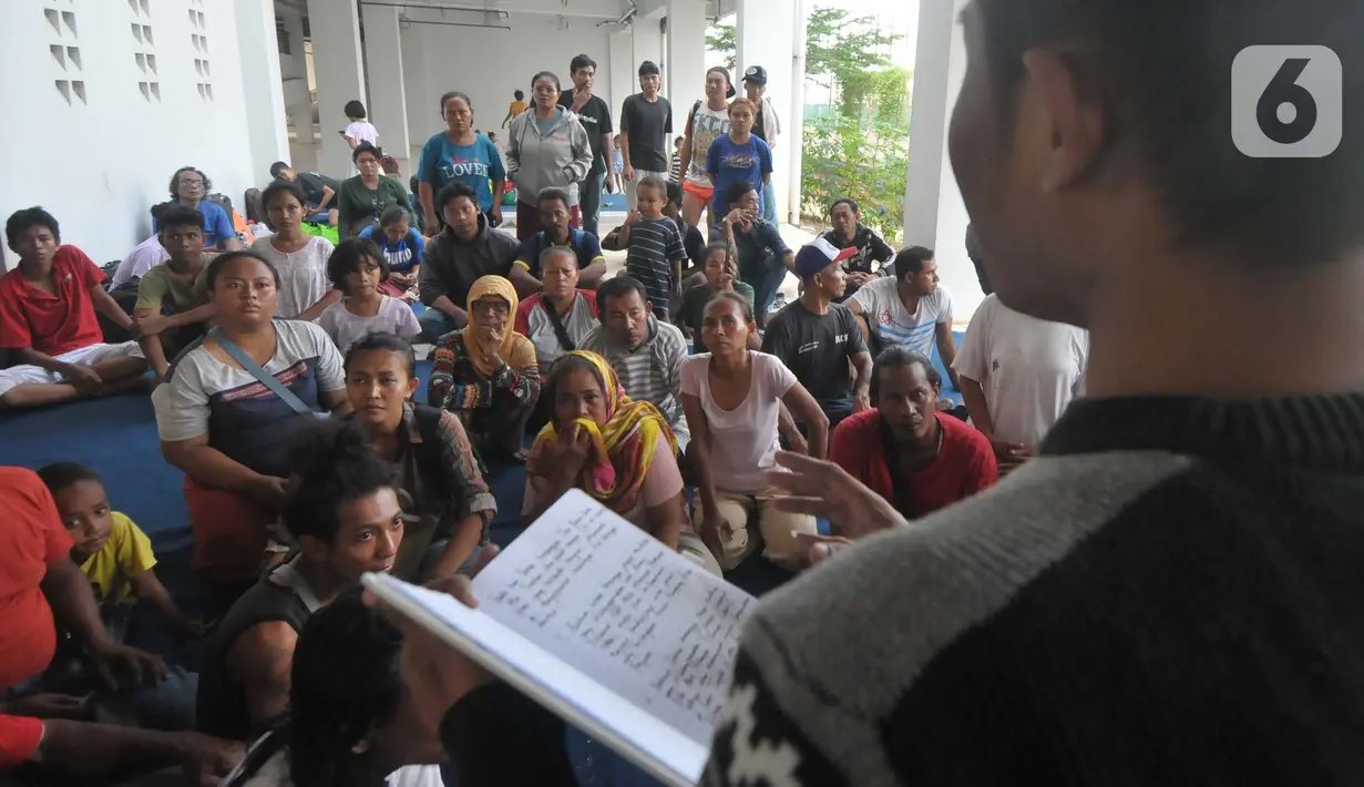 Puluhan warga duduk di pelataran rusun sambil melakukan mediasi dengan berbagai pihak, baik kuasa hukum, pihak kepolisian, dan lainnya. (merdeka.com/Imam Buhori)