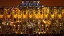 Orang-orang mengambil gambar Museum Seni Rupa yang diterangi selama Festival of Lights (Fete des Lumieres) di kota Lyon, Prancis, Kamis (5/12/2019). Festival yang digelar sejak tahun 1852 ini berlangsung, bertepatan dengan musim liburan Natal. (ROMAIN LAFABREGUE / AFP)