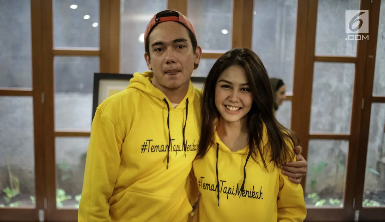 Adipati Dolken rangkul mesra Vanesha Prescilla saat sesi foto usai jumpa pers film Teman Tapi Menikah di Jakarta, Selasa (6/3). Film ini bercerita tentang persahabatan antara Adipati dengan Vanesha. (Liputan6.com/Faizal Fanani)