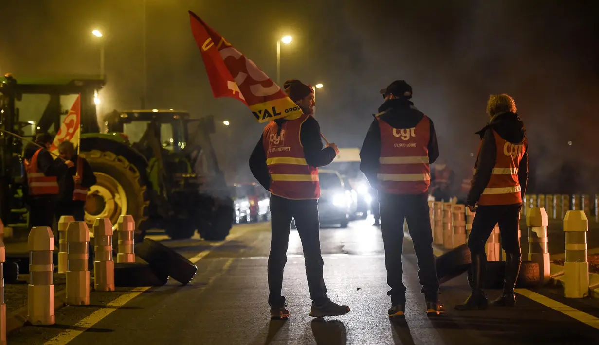 Para anggota serikat pekerja Konfederasi Umum Buruh (CGT) berpartisipasi dalam aksi perlambatan untuk menentang reformasi pensiun, di dekat bandara Nantes di Bouguenais, Prancis barat pada Kamis (16/2/2023). Prancis bersiap-siap menghadapi pemogokan baru dan demonstrasi massal menentang proposal Presiden Prancis untuk mereformasi pensiun Prancis, termasuk menaikkan usia pensiun dari 62 menjadi 64 tahun dan meningkatkan jumlah tahun orang harus memberikan kontribusi untuk mendapatkan pensiun penuh. (Sebastien SALOM-GOMIS/AFP)