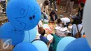 Sejumlah anak serius menyelesaikan lukisan dalam festival laut 2015 di taman Kridaloka,  Senayan, Jakarta, Sabtu (19/9/2015). Festival bertujuan untuk mengenalkan dunia laut Indonesia kepada masyarakat serta untuk menjaganya. (Liputan6.com/Angga Yuniar)
