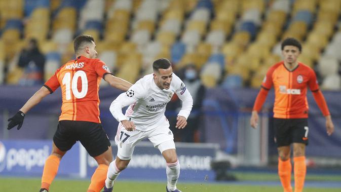 Penyerang Shakhtar Donetsk, Junior Moraes berebut bola dengan gelandang Lucas Vazquez pada matchday kelima Grup B Liga Champions di NSK Olimpiyskiy, Kiev, Rabu (2/12/2020) dini hari WIB. Real Madrid tumbang 0-2 di markas Shakhtar Donetsk. (AP Photo/Efrem Lukatsky)