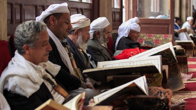Sejumlah pria membaca Al-Quran selama bulan Ramadan di Masjid Agung Sanaa, Yaman, Minggu (26/4/2020). Masjid Agung Sanaa merupakan salah satu masjid pertama yang dibangun atas perintah Nabi Muhammad SAW. (Mohammed HUWAIS/AFP)