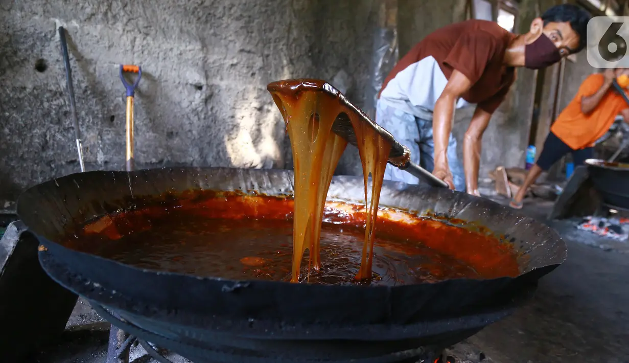 Pekerja mengaduk adonan dodol di pabrik dodol Betawi Mugi Jaya, Cilenggang, Tangerang Selatan, Rabu (13/5/2020). Produksi dodol selama pandemi Covid-19 tidak lebih dari 120 kg dibanding tahun lalu sebanyak 900 kg dodol. (Liputan6.com/Fery Pradolo)