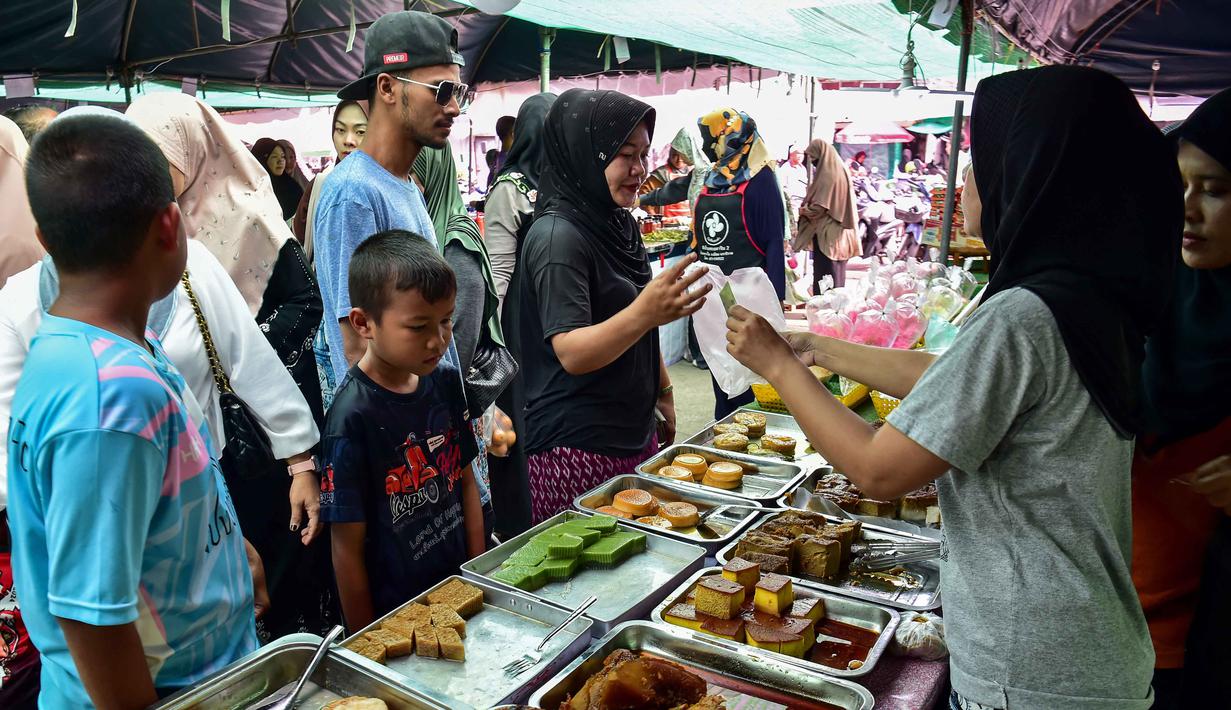 Orang-orang membeli makanan untuk berbuka puasa pada hari pertama bulan suci Ramadan 1447 Hijriah di sebuah pasar di provinsi Narathiwat, Thailand selatan, pada Kamis 19 Februari 2026. Jelang waktu berbuka puasa di hari pertama Ramadan 1447 Hijriah, suasana pasar-pasar lokal di provinsi Narathiwat, Thailand Selatan, terlihat semarak. (Madaree TOHLALA/AFP)