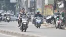 Pengendara sepeda motor tanpa mengenakan helm dan masker melintas di Jalan Pasar Minggu, Jakarta, Rabu (8/4/2020). Organisasi Kesehatan Dunia (WHO) telah merekomendasikan agar menggunakan masker saat berada di tempat umum demi memutus mata rantai penyebaran virus Corona. (merdeka.com/Iqbal Nugroho)