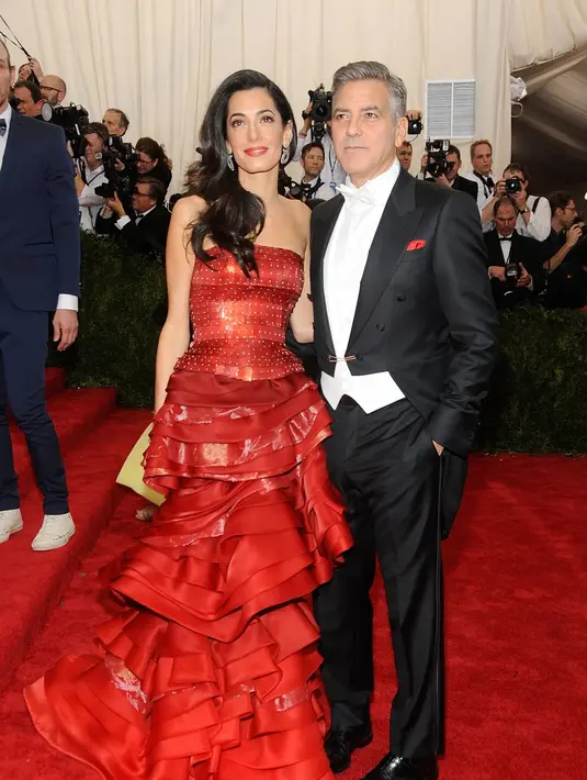 Amal dan George Clooney secara resmi muncul sebagai pasangan di Met Gala tahun 2015. George Clooney tampil dengan tuxedo dari Armani, sedangkan Amal tampil cantik dengan kostum yang dirancang oleh John Galliano untuk Maison Margiela. Foto: Vogue.