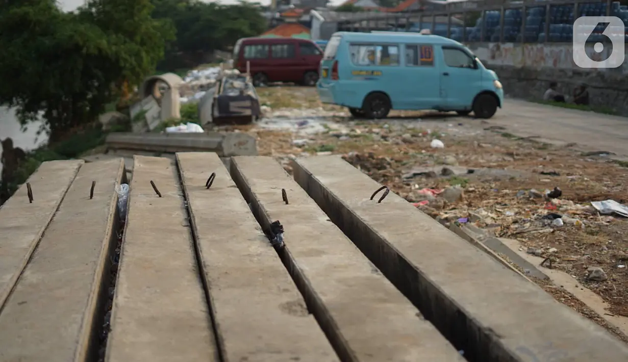 Tiang pancang dan saluran gorong-gorong menghiasi bantaran Sungai Ciliwung di kawasan Rawajati, Jakarta, Rabu (30/10/2019). Tiang-tiang pancang itu merupakan sisa proyek normalisasi Sungai Ciliwung dan telah berada di bantaran tersebut selama beberapa tahun terakhir. (Liputan6.com/Immanuel Antonius)