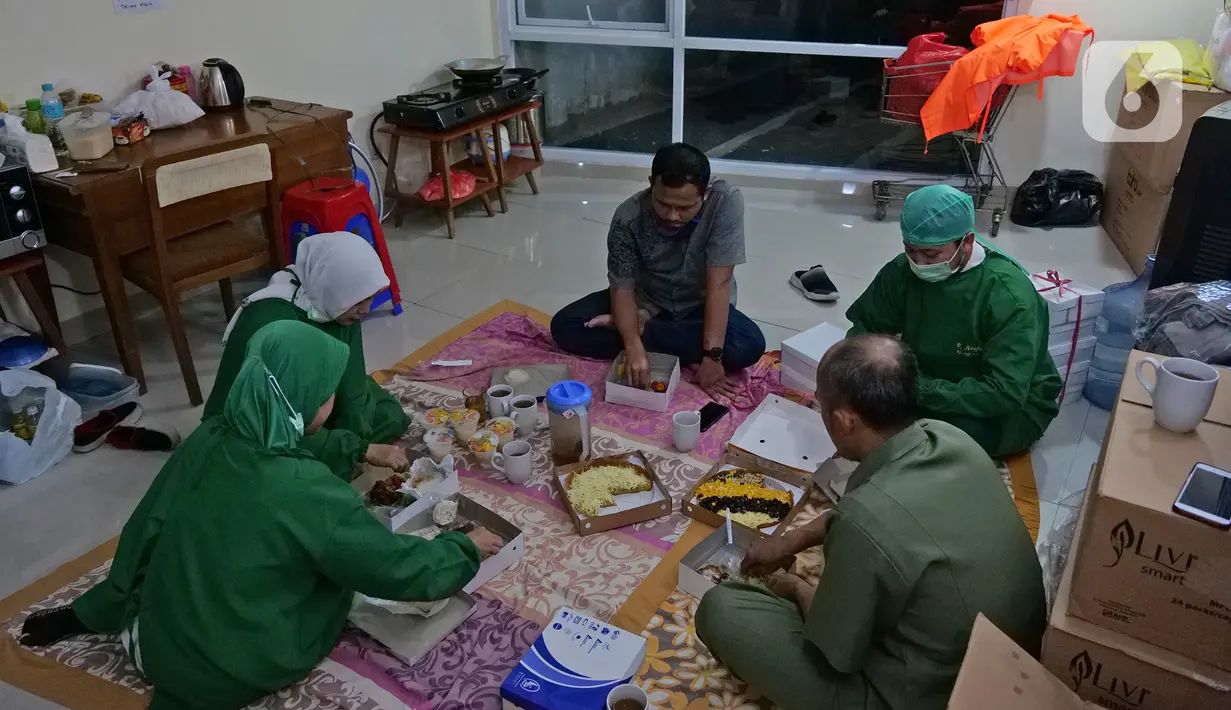 Para perawat berbuka puasa usai memeriksa pasien di Rumah Sakit Haji, Jakarta, Jumat (9/5/2020). Garda terdepan penanganan Covid-19 ini tetap menjalani bulan suci Ramadan di sela-sela menangani pasien terinfeksi dengan melakukan tadarus Quran dan buka puasa bersama. (Liputan6.com/Herman Zakharia)