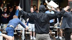 Seorang suporter Rusia melempar kursi ke arah fans Inggris saat bentrok antara kedua kubu di Lille, Prancis, Selasa (14/6/2016) atau Rabu dini hari WIB. (AFP/Leon Neal)