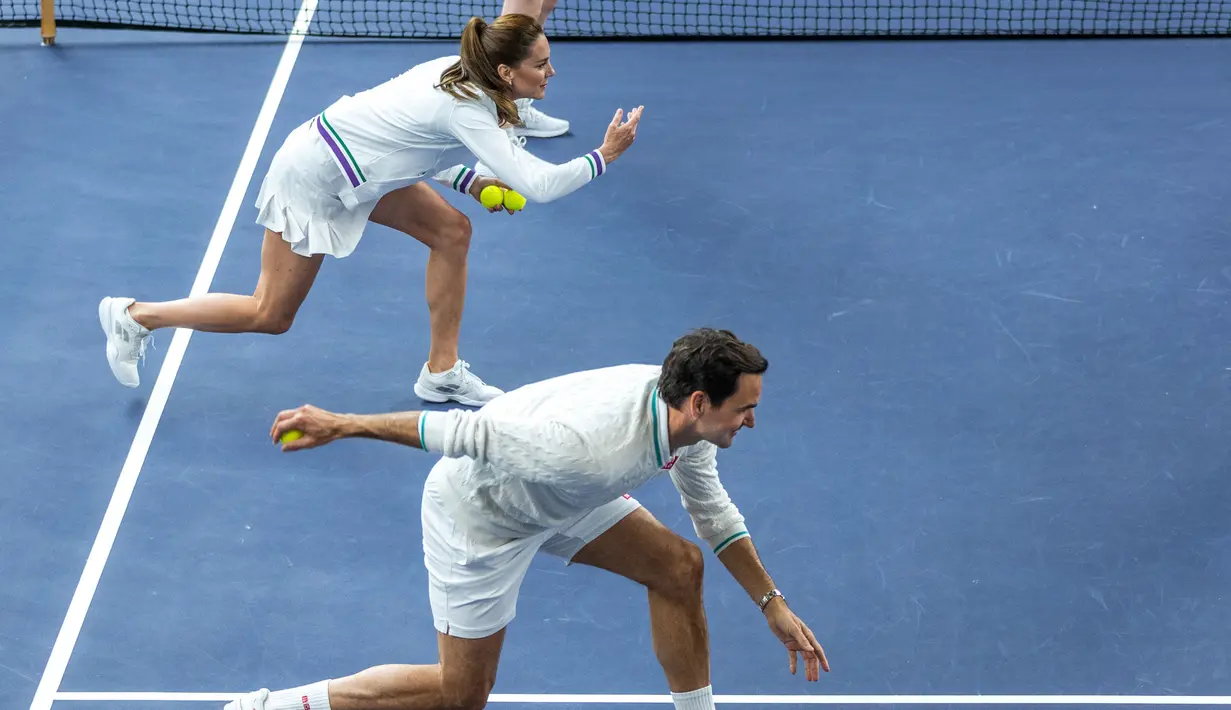 Princess of Wales, Kate Middleton (kiri), dan petenis, Roger Federer, mempraktekan apa yang biasa dilakukan ball boy disela-sela pertandingan ekshibisi jelang Turnamen Tenis Grand Slam Wimbledon 2023 di The All England Tennis Club in Wimbledon, Sabtu (24/6/2023). (AFP/AELTC/Thomas Lovelock)