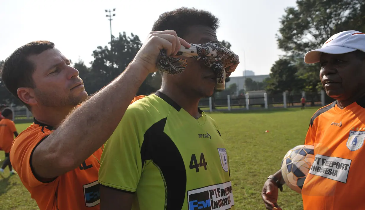 Liputan6.com berkesempatan mengajak pemain Persipura bermain games di Lapangan C Senayan, Jakarta (8/5/2015). Pelatih Oswaldo Lessa (kiri) memakaikan penutup mata ke pemain Persipura Yohanis Tjoe.  (Liputan6.com/Herman Zakharia)