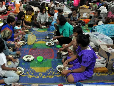 Sejumlah pengungsi terlihat berbuka puasa di pengungsian letusan Gunung Sinabung di Desa Batu Karang, Medan, Sabtu (4/7/2015). Pengungsi yang muslim tetap menjalankan puasa dengan menu sahur dan berbuka seadanya. (Liputan6.com/JohanTallo)
