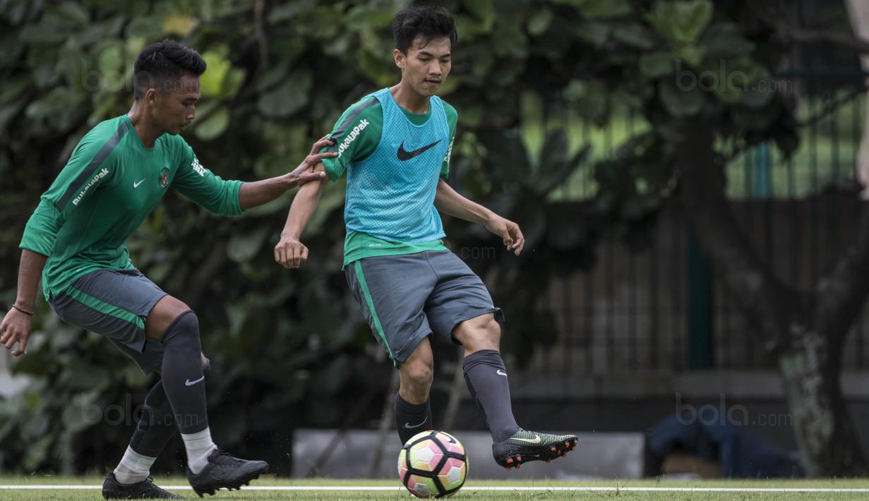 Pemain Timnas Indonesia, Muhammad Iqbal, berusaha melewati Bagas Adi saat latihan di Lapangan ABC Senayan, Jakarta, Jumat (19/1/2018). Pemusatan latihan ini dilakukan jelang Asian Games 2018. (Bola.com/Vitalis Yogi Trisna)