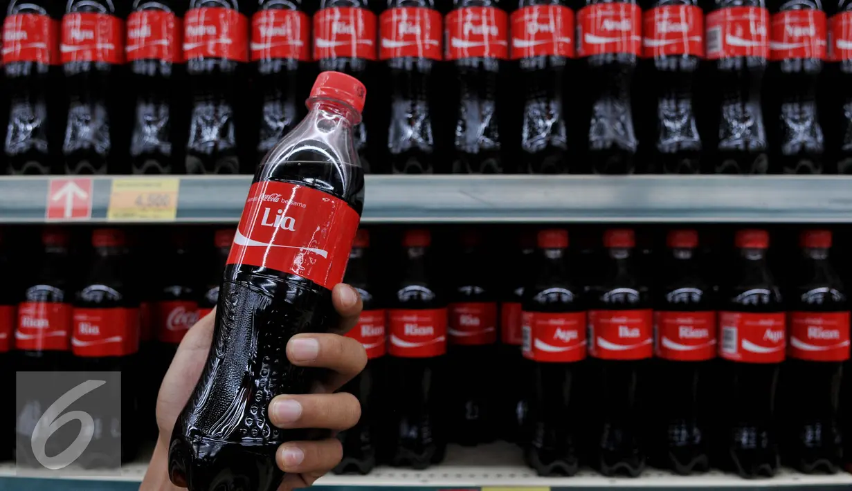 Konsumen menunjukkan kemasan botol Coca cola di Gandaria City, Jakarta, Senin (10/8/2015). Coca cola menempatkan nama populer di Indonesia pada kemasannya yang merupakan bentuk kampanye global 'Share A Coke'. (Liputan6.com/JohanTallo)