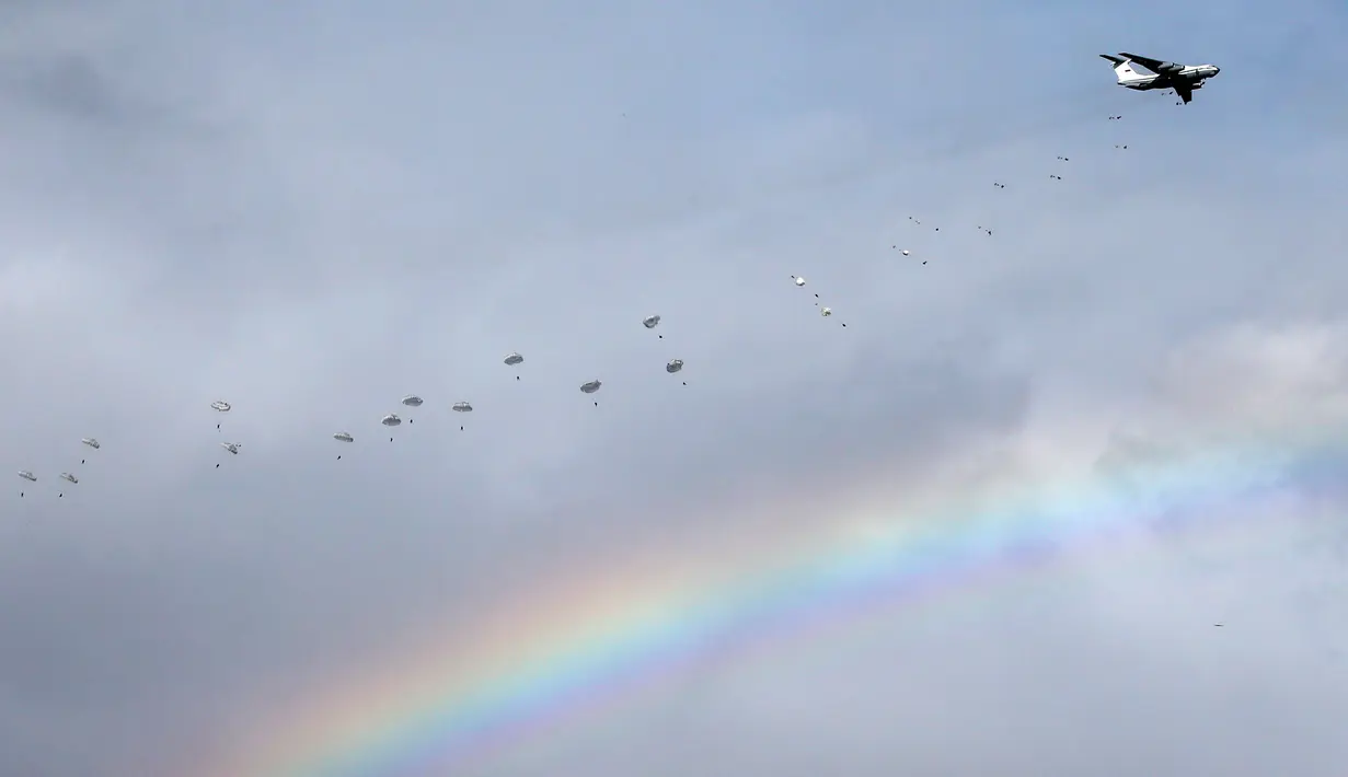Pesawat IL-76 mengeluarkan para pasukan terjun payung saat muncul pelangi dalam latihan gabungan militer Serbia dengan Rusia yang bernama Slavic Brotherhood di kota Kovin, dekat Belgrade, Serbia (7/11). (Reuters/Marko Djurica)