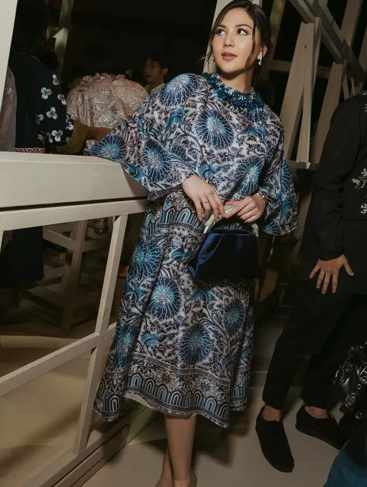 Jessica Mila memadukannya dengan handbag navy dengan aksen silver pada bagian handle. Tas dari brand Rodo ini ditaksir seharga Rp13,3 serta heels pitanya. [@biyanofficial]