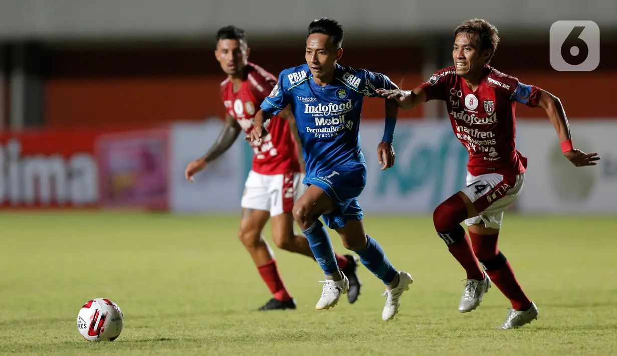 Pemain Bali United, Fadil (kanan), berebut bola dengan pemain Persib Bandung, Beckham Putra Nugraha, dalam pertandingan Babak Penyisihan Piala Menpora 2021 di Stadion Maguwoharjo, Sleman. Rabu (24/3/2021). Persib bermain imbang 1-1 dengan Bali United. (Bola.com/Arief Bagus)