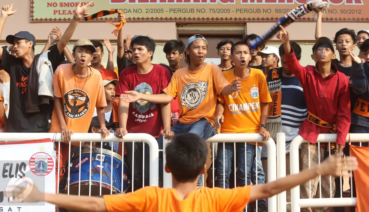 Pendukung klub Persija Jakarta, The Jakmania memberi semangat klub Persija Jakarta saat berlatih di Lapangan Banteng, Jakarta, Selasa (11/4). (Liputan6.com/Immanuel Antonius)