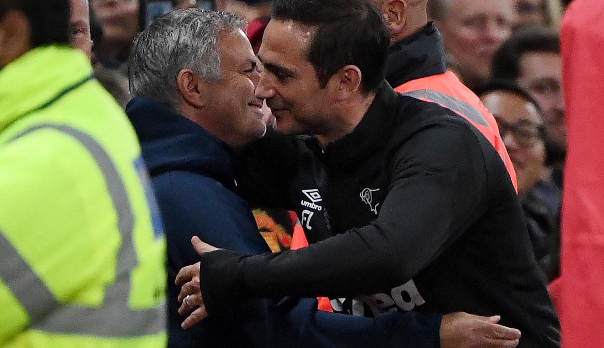 Pelatih Derby County, Frank Lampard, berpelukan dengan pelatih Manchester United, Jose Mourinho, pada Piala Liga Inggris di Stadion Old Trafford, Rabu (26/9/2018). Manchester United takluk adu penalti 9-10 (2-2) dari Derby County. (AFP/Paul Ellis)