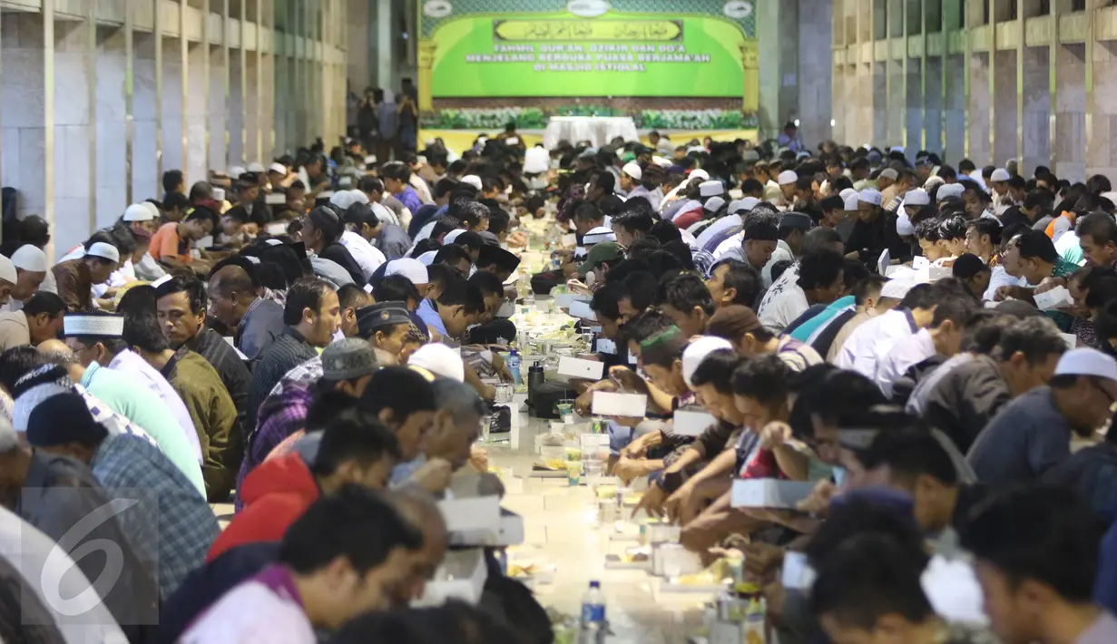 Ribuan umat muslim menyantap makanan buka puasa di Masjid Istiqlal, Jakarta, Jumat (10/6). Masjid Istiqlal selama sebulan menyediakan 3.000-4.000 boks nasi untuk berbuka puasa. (Liputan6.com/Immanuel Antonius)