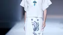 Seorang model berjalan diatas catwalk mengenakan rok putih bermotif seperti batik lasem cina rancangan desainer Xuefei Sun saat China Fashion Week di Beijing, Tiongkok (30/10). (AFP/STR)