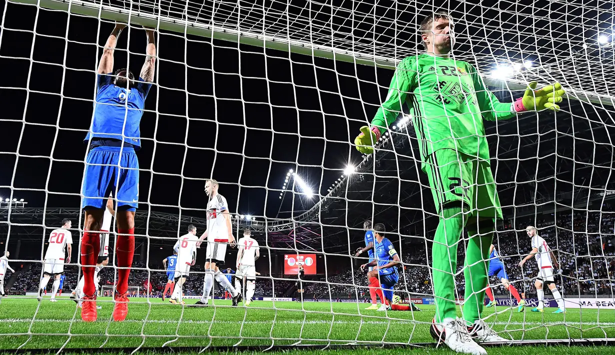 Olivier Giroud (kiri) memegang mistar gawang saat gagal menaklukan kiper Belarusia, Andrey Harbunow pada kualifikasi Piala Dunia 2018 di Borisov Arena, Borisov, Belarusia. (AFP/Franck Fife)