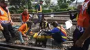 Petugas memperbaiki rel Kereta rel listrik (KRL) Jabodetabek rute Depok-Jatinegara yang mengalami anjlok di Stasiun Jatinegara, Jakarta Timur, Senin (30/10). Peristiwa itu berdampak keterlambatan perjalanan kereta lainnya. (Liputan6.com/Immanuel Antonius)