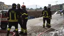 Petugas pemadam kebakaran berjaga di lokasi jalanan yang ambles di dekat sungai Arno di Lungarno Torrigiani, Florence, Italia (25/5). Kejadian tersebut disebabkan oleh pecahnya pipa besar saluran air. (AFP PHOTO/CLAUDIO GIOVANNINI)