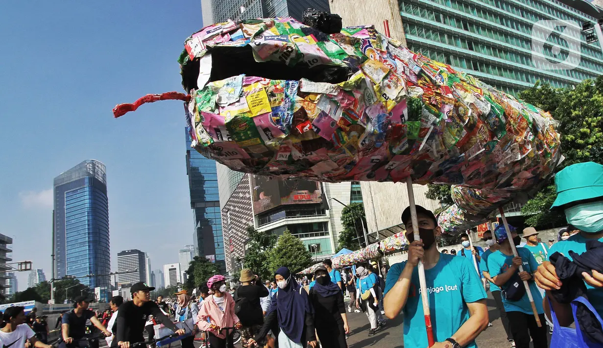 Sejumlah aktivis dari berbagai organisasi melakukan Aksi pawai bebas plastik saat Hari Bebas Kendaraan (Car Free Day) di Jakarta, Minggu (24/7/2022). Aksi tersebut mengajak masyarakat untuk peduli lingkungan dari sampah plastik kemasan atau sekali pakai yang saat ini banyak mencemari laut di Indonesia. (Liputan6.com/Angga Yuniar)