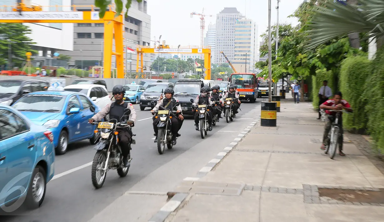 Sejumlah anggota polisi berkendara motor dengan senjata lengkap melintasi kawasan Jalan MH Thamrin, Jakarta, Jumat (15/1).  Pasca-teror di kawasan Sarinah, Polri meningkatkan status keamanan Indonesia menjadi siaga satu. (Liputan6.com/Faizal Fanani)