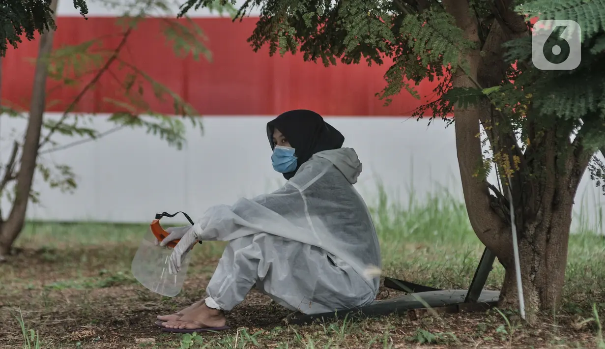 Anggota Tim Sterilisasi \beristirahat disela tugasnya mencuci sepatu tenaga kesehatan di RSD Wisma Atlet Kemayoran, Jakarta. Dalam sehari Tim Sterilisasi mampu mencuci hingga 300 pasang sepatu yang telah digunakan tenaga kesehatan yang bertugas menangani pasien Covid-19. (merdeka.com/Iqbal Nugroho)