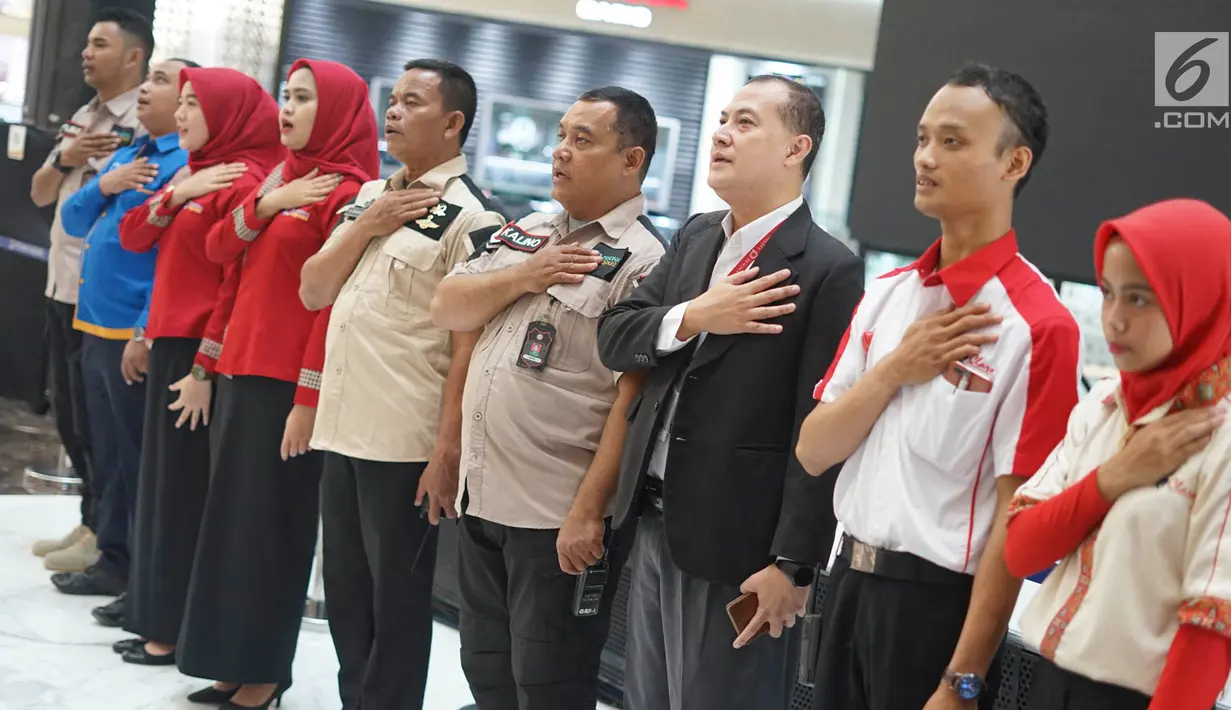 Karyawan menyanyikan lagu Indonesia Raya di Mal Pesona Square, Depok, Jawa Barat, Rabu (19/6/2019). Pemutaran lagu Indonesia Raya di mal tersebut untuk menumbuhkan rasa nasionalisme pada karyawan. (Liputan6.com/Immanuel Antonius)