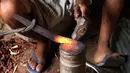 Foto 4 Agustus 2018, perajin membuat pisau tradisional, jambiya, dari sisa-sisa rudal di Hajjah, Yaman. Mereka mengumpulkan serpihan logam sisa-sisa dari rudal yang ditembakkan Koalisi Arab Saudi dan mengubahnya menjadi belati jambiya. (AP/Hammadi Issa)