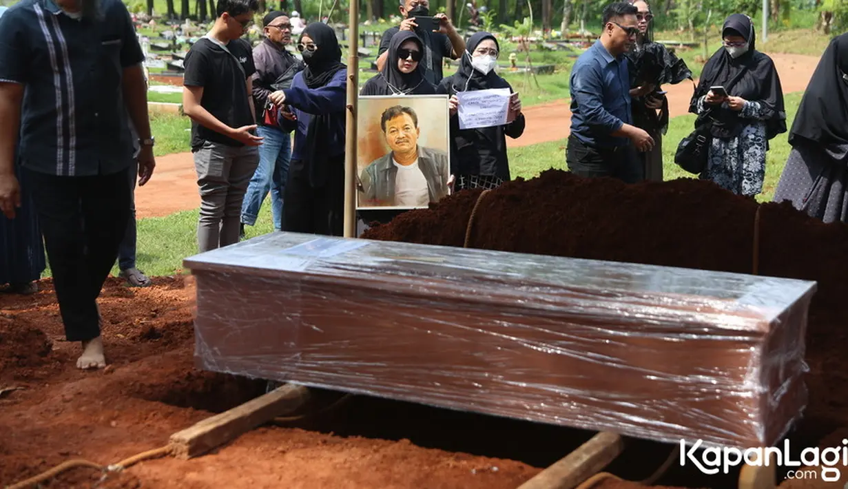 Peti jenazah Eeng warna cokelat dengan dibalut plastik. Sesuai protokol kesehatan, pemakaman jenazah covid-19 menggunakan peti dan dibungkus plastik. Sebelumnya, Eeng dikabarkan meninggal akibat terpapar covid-19. [Foto: Budy Santoso/KapanLagi.com]