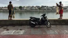 Warga yang hendak menjala ikan memarkirkan kendaraannya di trotoar Danau Sunter, Jakarta, Jumat (19/1). Meskipun telah dibenahi, masih banyak warga yang memarkirkan sepeda motornya di trotoar tersebut. (Liputan6.com/Immanuel Antonius)