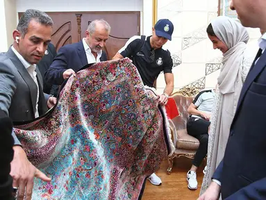 Pemain Al-Nassr, Cristiano Ronaldo menerima karpet permadani Persia saat tiba di Imam Khomeini International Airport, Tehran menjelang laga Liga Champions Asia 2023 melawan Persepolis FC, Selasa (19/09/2023). (AFP/Persepolis FC)