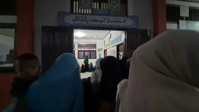 Warga sekitar berkerumun di depan ruang kelas lokasi penampungan pengungsi Muslim-Rohingya di Pidie (Liputan6.com/Rino Abonita)