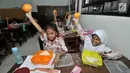 <p>Sejumlah siswi menunjukkan salah satu menu makanan tambahan saat program Penyediaan Makanan Tambahan Anak Sekolah (PMTAS) di SD Negeri 01 Tanjung Priok, Jakarta, Kamis (28/3). (merdeka.com/Iqbal S. Nugroho)</p>