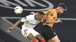 Pemain Sevilla, Fernando, berebut bola dengan pemain Wolverhampton Wanderers, Leander Dendoncker, pada perempat final Liga Europa, Selasa (11/8/2020). Sevilla menang dengan skor 1-0. (Ina Fassbender/Pool Photo via AP)