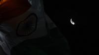 Fenomena gerhana bulan sebagian (parsial) terlihat selama gerhana bulan di samping bendera Nasional India di Chennai pada Rabu (17/7/2019) dini hari. Gerhana bulan parsial ini bisa diamati dari Amerika Selatan, Eropa, Afrika, Asia dan Australia. (ARUN SANKAR/AFP)